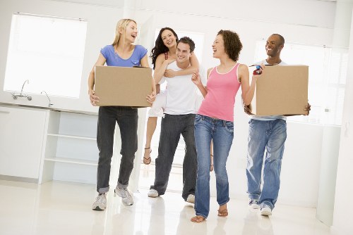 Professional movers handling flat removals in Stpaulscray near an apartment entrance